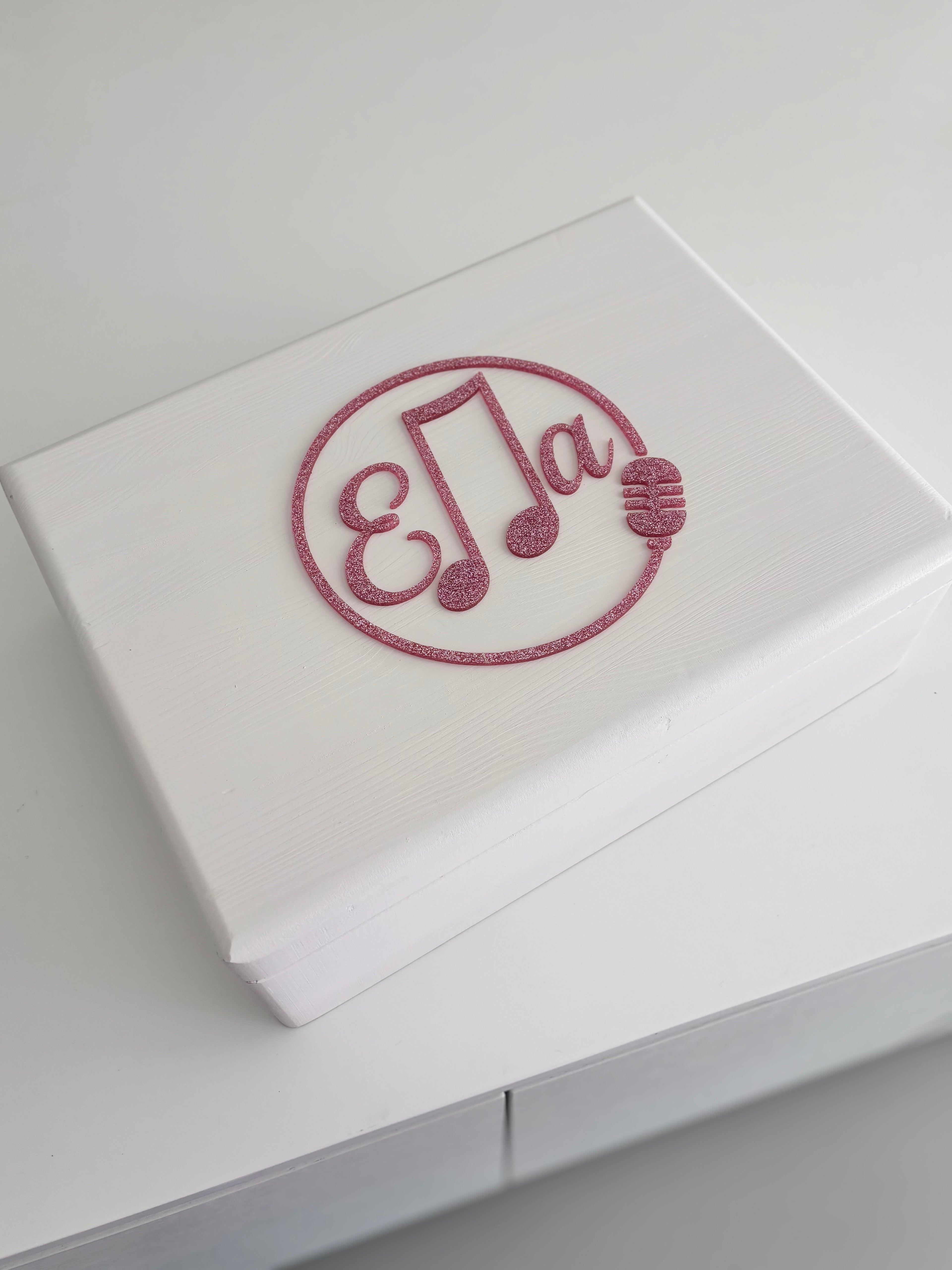 White keepsake box with a decorative acrylic name 'Ella' on a light grey background