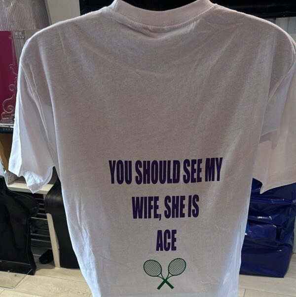 White t-shirt with personalised text and tennis racket graphics on a plain background