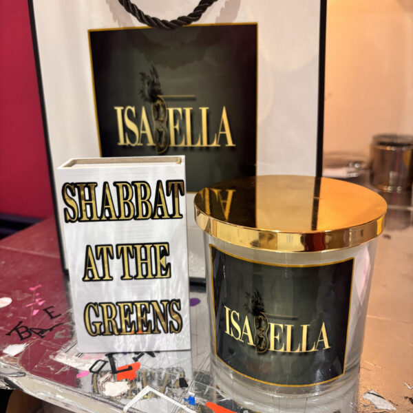 Isaella candle with gold lid and 'Shabbat at the Greens' sign in the background