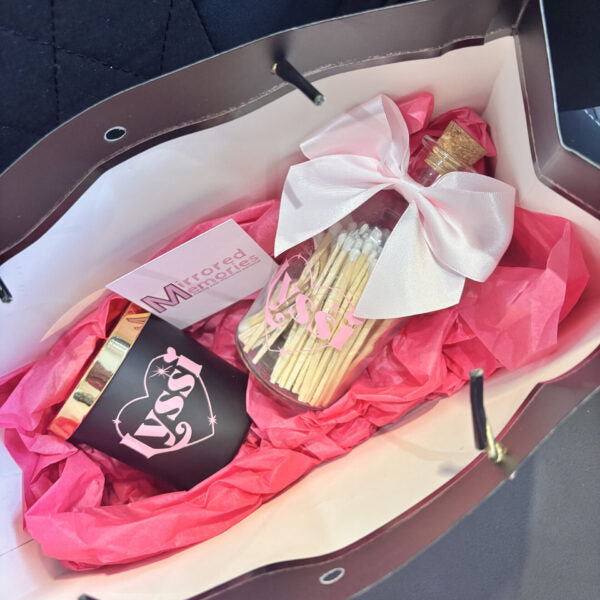 Decorative personalised candle with matchsticks and pink tissue paper.