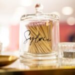 Glass bottle matches labelled 'Sylvie' with matches on a blurred background