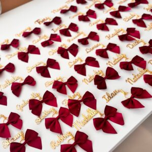Acrylic Place Names red bows with gold acrylic name tags