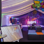 Decorated event space with colourful balloons and a 'Mylar' bespoke mirror