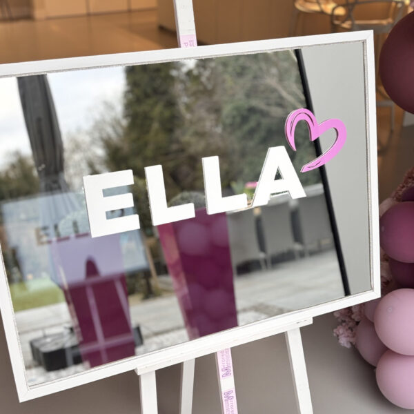 Bespoke mirror white-framed with 'ELLA' and a heart sticker, surrounded by pink balloons.