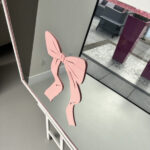 Pink bow-shaped acrylic name on a bespoke mirror.