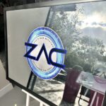 ZAC logo on a bespoke mirror surface with outdoor view