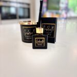 Black and gold diffuser, candle and match box set 'Gabrielle' on a white surface with a blurred background