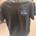 Black event t-shirt with a logo on a mannequin against a neutral background