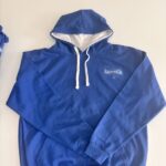 Blue hoodie with a logo on a beige background