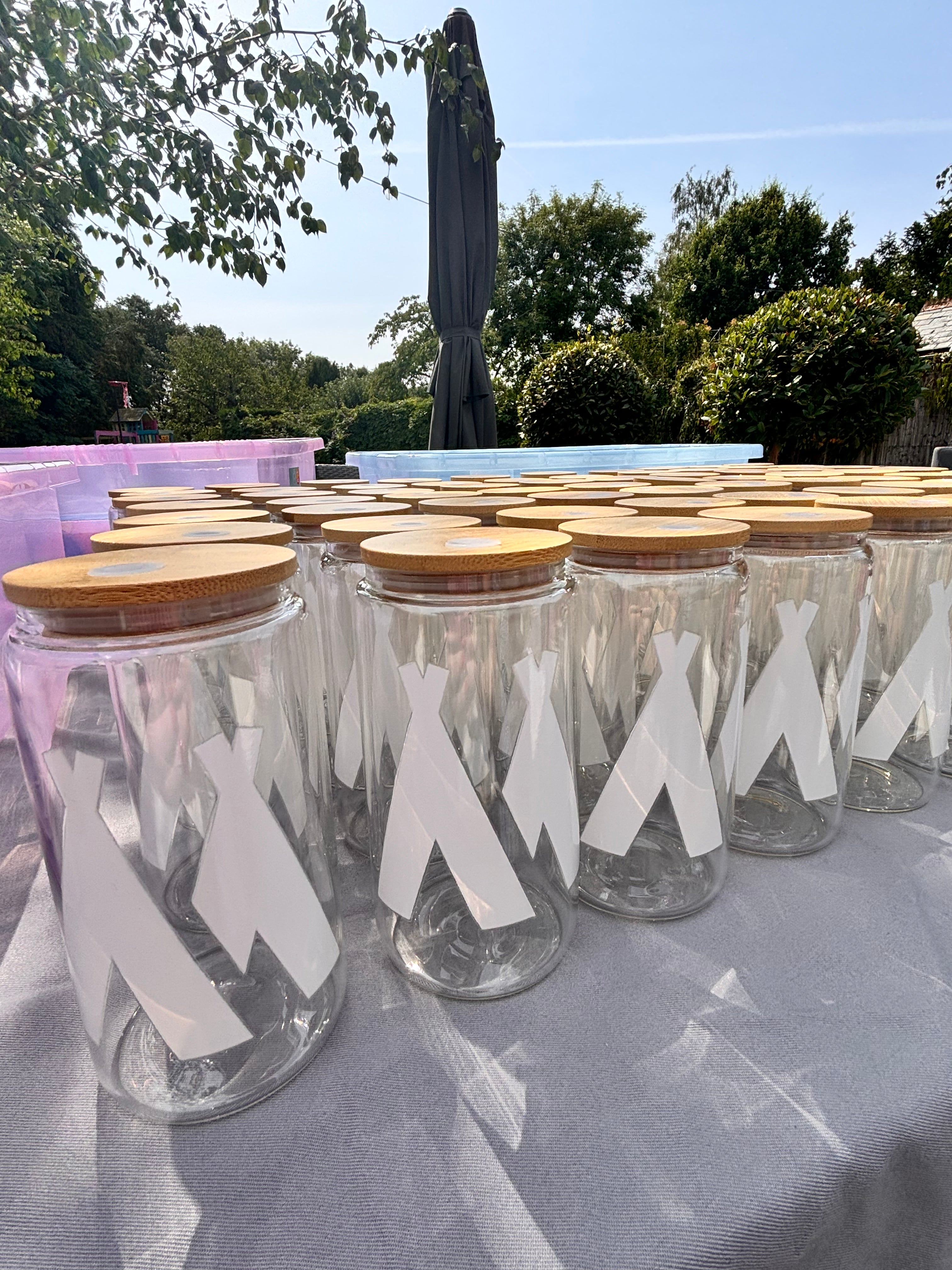 Decorative cold cups with white labels on a stand outdoors