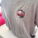 Grey event t-shirt with 'Bella' logo on a mannequin