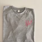 Grey event t-shirt with a red logo