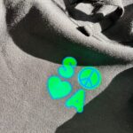 Neon green 'SOSA' logo on black hoodie