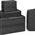 Set of black packing cubes in various sizes on a white background