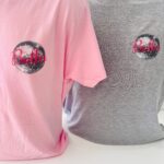Pink and grey event t-shirts with 'Bella' logo on a white background