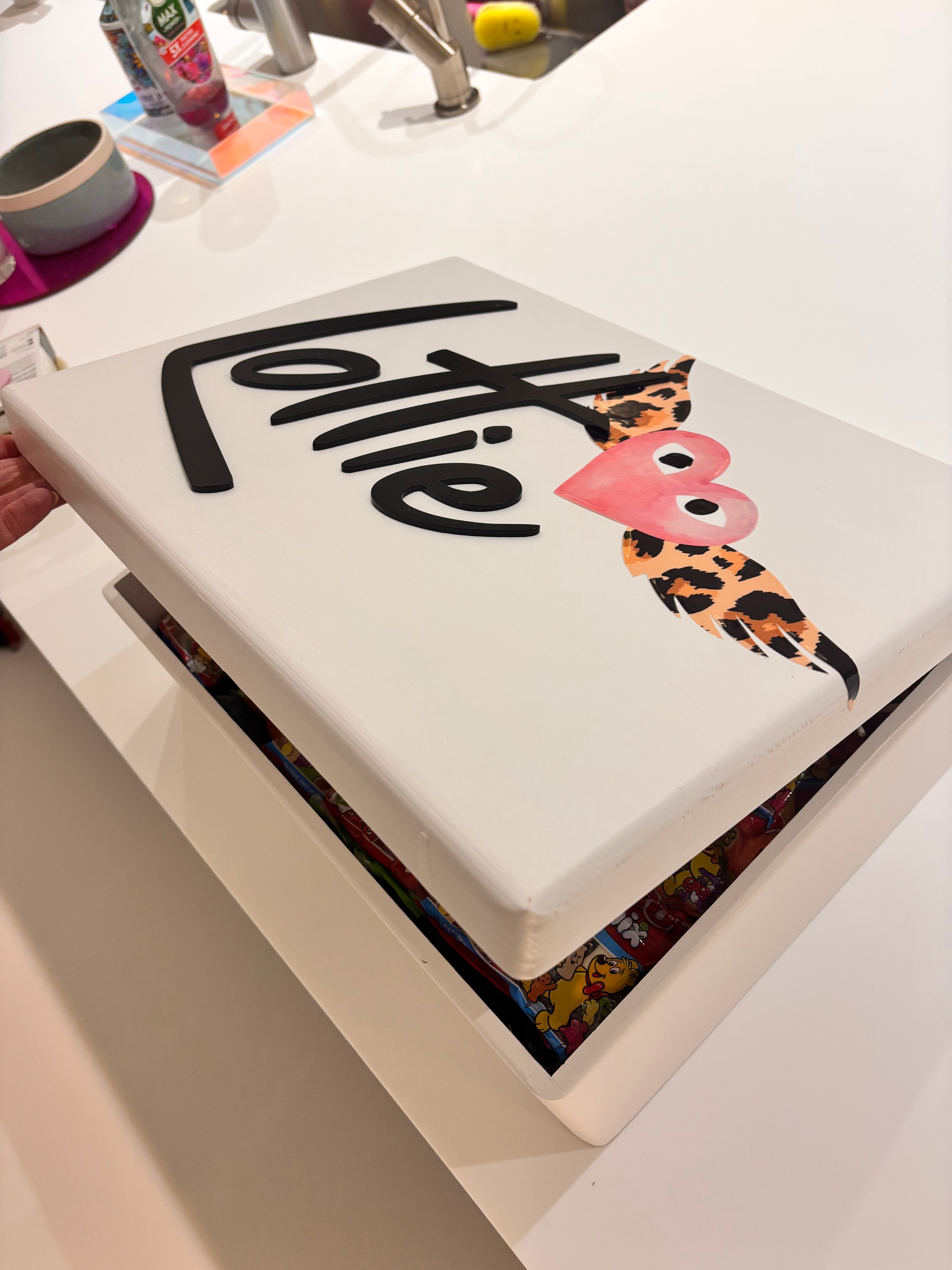 White keepsake box with 'Lottie' branding and decorative heart design on a white background
