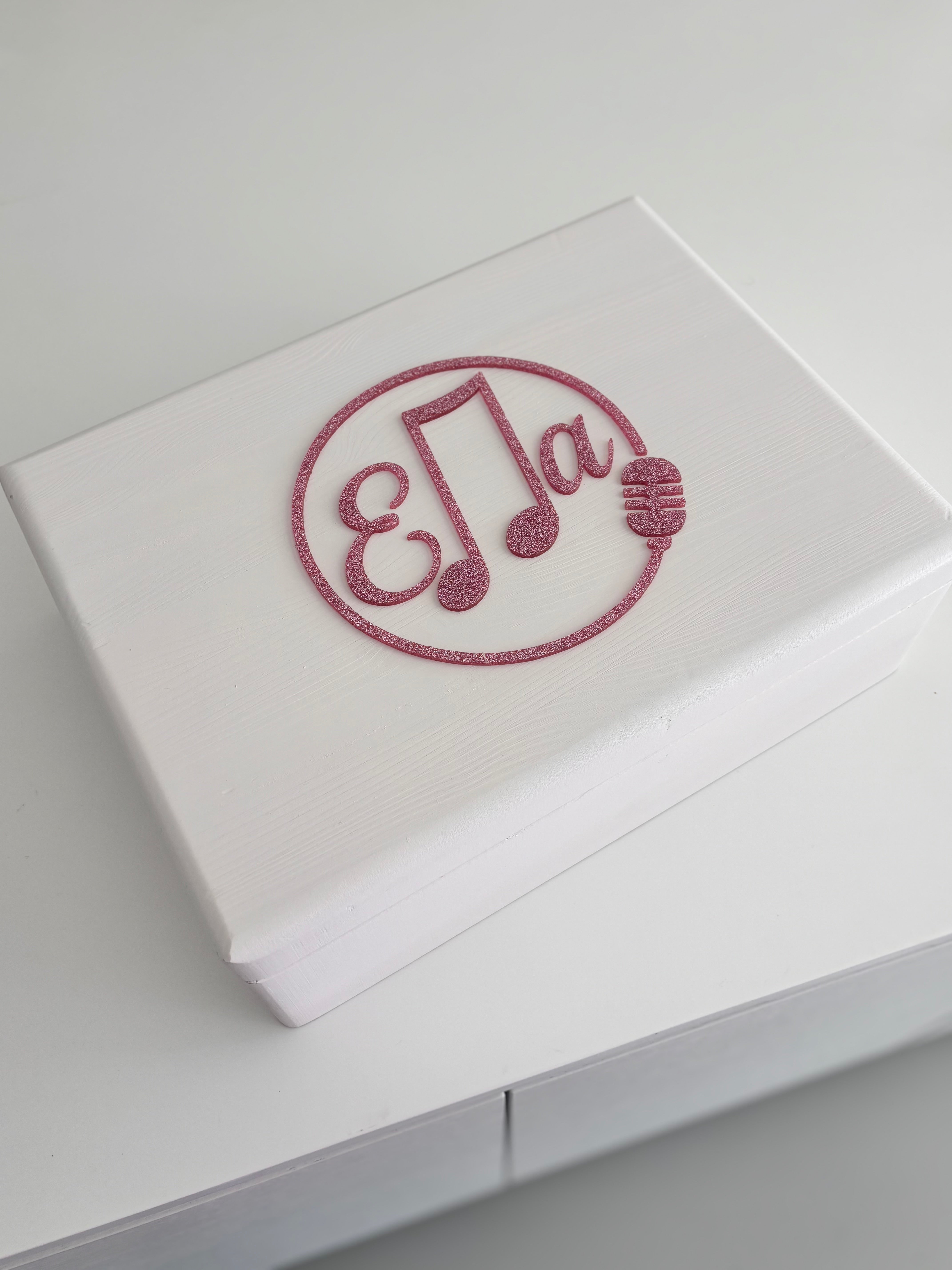 White keepsake box with a decorative acrylic name 'Ella' on a light grey background