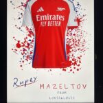 Red and white Arsenal football shirt gift with Emirates branding on a white background with red and blue splashes.