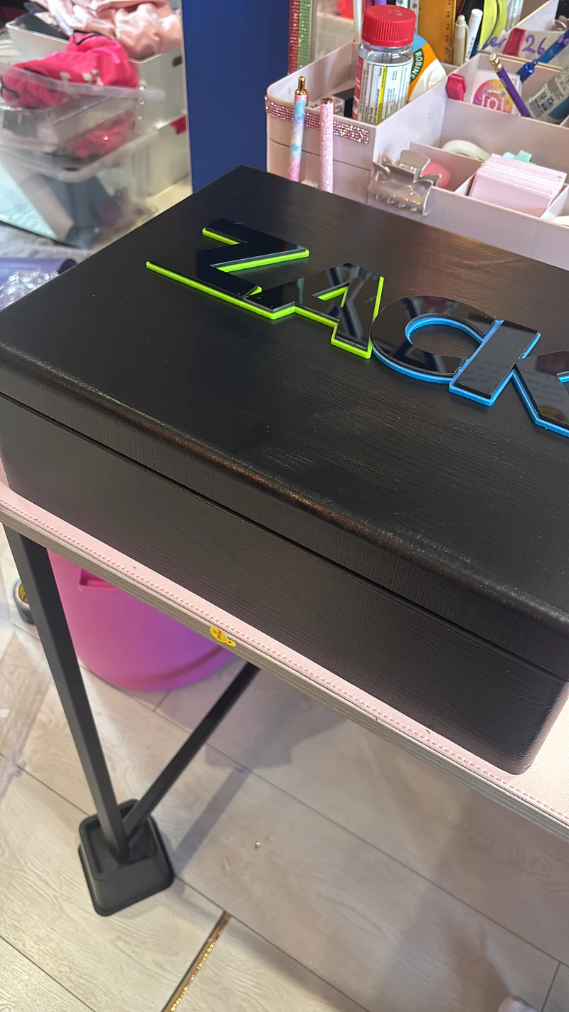 Black_keepsake_box_with_green_logo_on_a_store_shelf