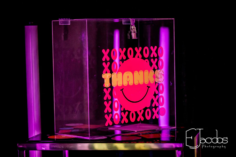 Clear_gift_card_box_with_pink_and_yellow_design_featuring_THANKS_and_XOXO_on_a_black_background.