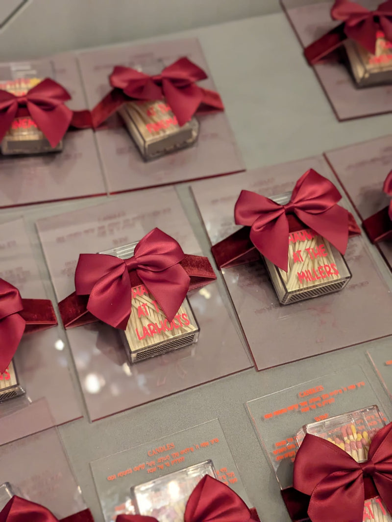 Faith_gift_of_clear_match_boxes_with_red_writing_and_a_large_red_bow