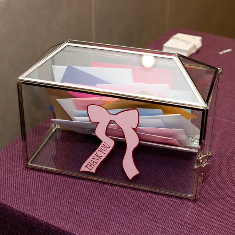 Glass_gift_card_box_with_pink_bow_on_a_purple_tablecloth