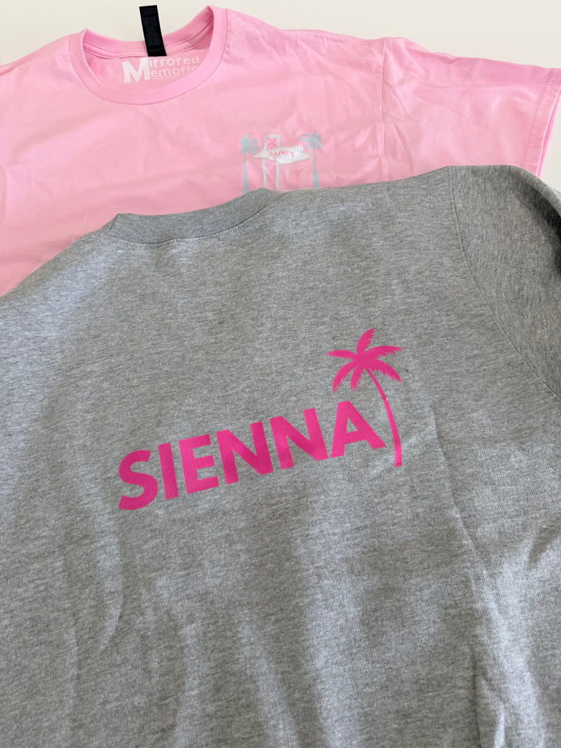Grey_crewneck_shirt_with_pink_SIENNA_logo_and_pink_sleeveless_top_on_a_light_background
