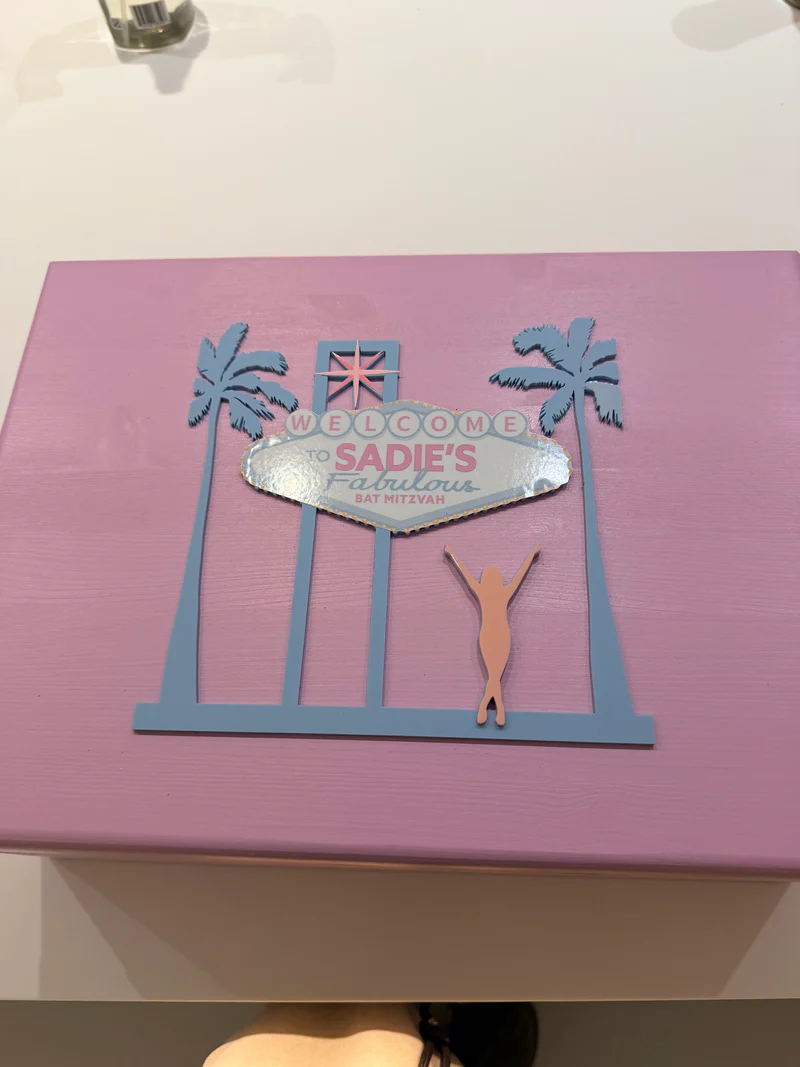 Pink_keepsake_box_with_cut-out_designs_and_Welcome_Sadie_s_text_on_a_white_background