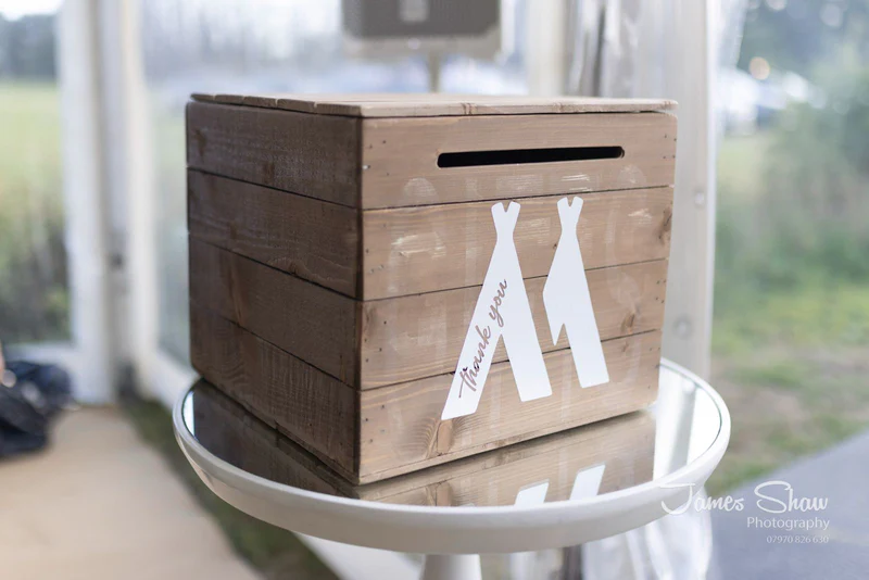 Wooden_gift_card_box_with_cut-out_shapes_on_a_glass_table_and_thank_you_in_white_writing